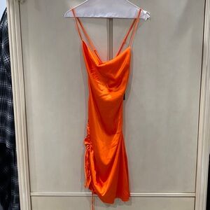 mini slip dress. Adjustable spaghetti straps and sidetie. Has a side zipper